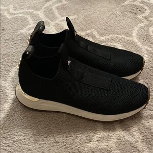 Michael Kors Black Knit Slip-On Sneakers with White Sole and Gold Accent